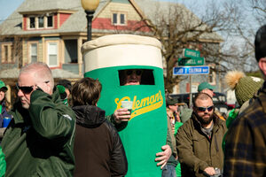 The Coleman’s Authentic Irish Pub Green Beer mascot holds its own green beer to celebrate. Hundreds of attendees gather at Coleman’s for Green Beer Sunday, an event that has happened every year in Syracuse for more than 50 years.