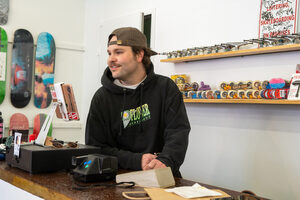 Charlie Giancola converses with customers who visit Flower Skate Shop’s new location, which opened last Saturday. 
